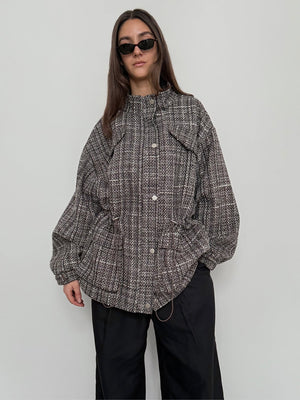 Oversized checkered jacket with drawstring details, styled with black pants and sunglasses, showcasing MEOTINE's unique design.