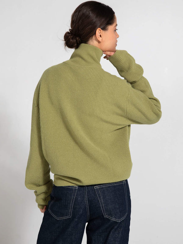 Cozy green ribbed sweater with a high neck, featuring a relaxed fit and long sleeves, perfect for a casual look by MEOTINE.