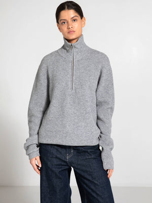Cozy gray zip-up sweater with a high collar, paired with dark jeans, showcasing a relaxed fit. Perfect for casual wear by MEOTINE.