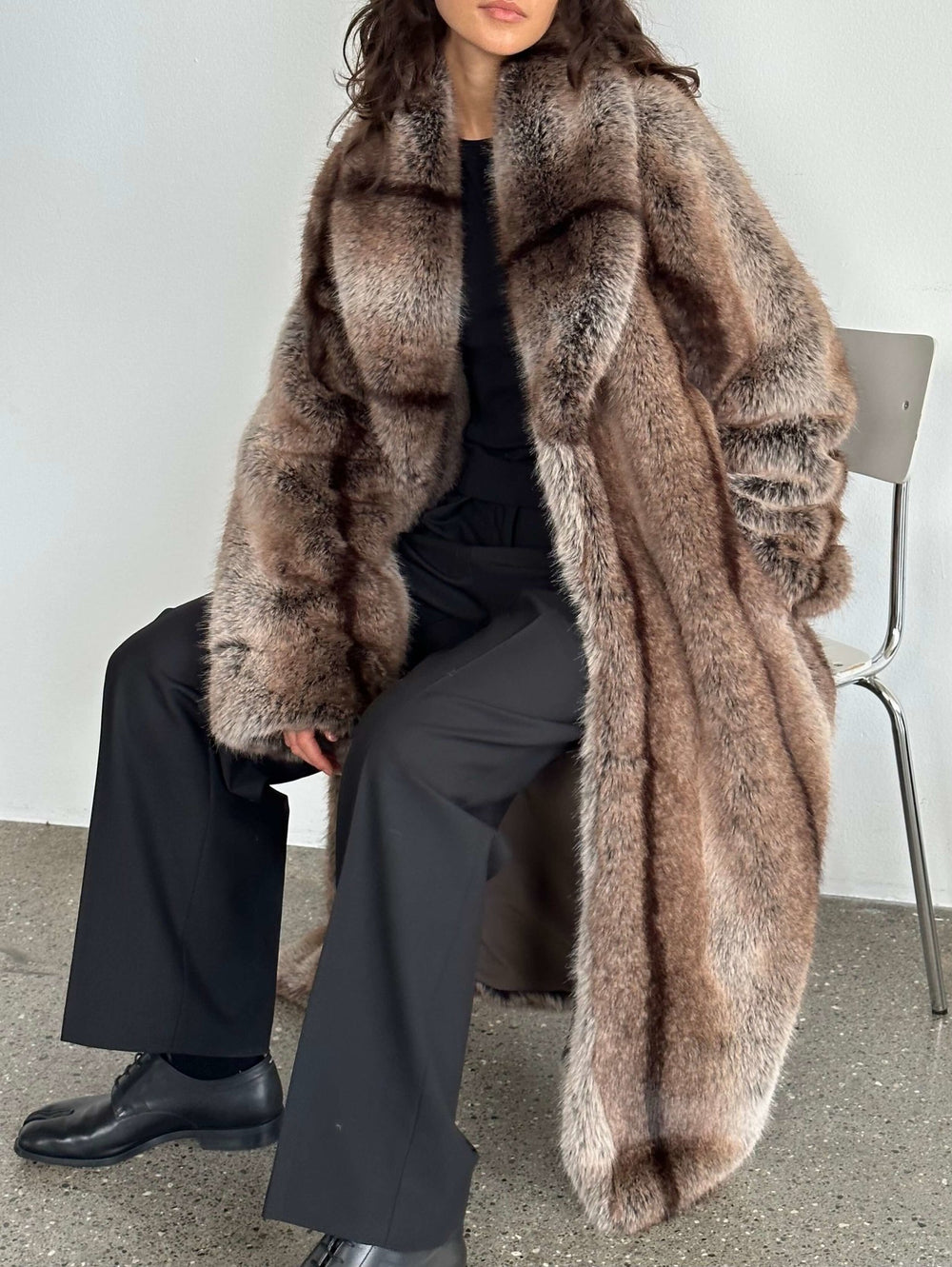 Luxurious oversized faux fur coat in soft brown tones, featuring a wide collar and relaxed fit, perfect for stylish warmth by MEOTINE.