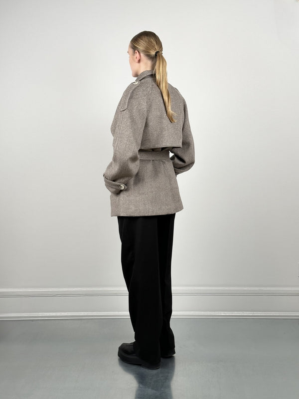 A model showcases a stylish brown cropped jacket with a belted waist, paired with black wide-leg pants, by MEOTINE.