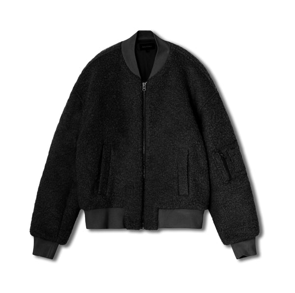 Cozy black bomber jacket with a textured finish and ribbed cuffs, featuring zippered pockets. Perfect for stylish warmth by MEOTINE.