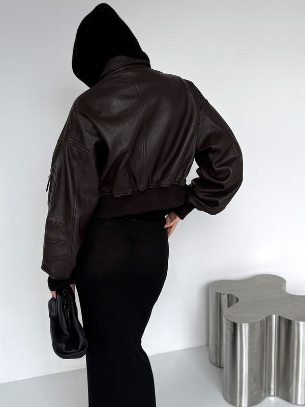Chic brown leather cropped jacket with a relaxed fit, paired with a sleek black dress, showcasing a modern, stylish look by MEOTINE.