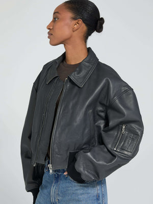 Stylish black leather cropped jacket with a zip closure and oversized fit, perfect for a trendy look by MEOTINE.