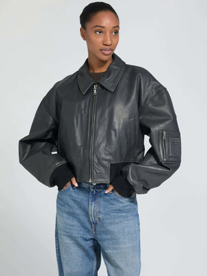 Stylish black leather cropped jacket with a relaxed fit, featuring a zip closure and ribbed cuffs, perfect for a trendy look. MEOTINE.