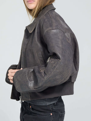 Stylish cropped leather jacket in dark brown, featuring a zip closure and side pockets, perfect for a trendy look by MEOTINE.