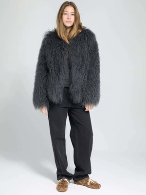 A model wearing a fluffy gray MEOTINE coat paired with black pants and brown shoes, set against a light gray background.
