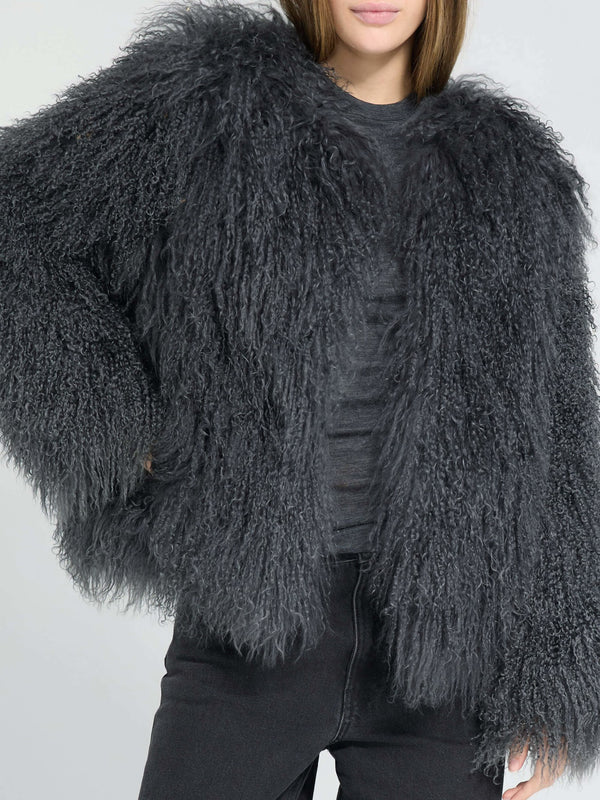 A model showcases a fluffy, dark gray MEOTINE jacket with a cozy, oversized fit, paired with black jeans for a stylish look.