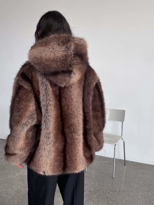 A model wearing a luxurious brown fur coat with a hood, showcasing the soft texture and elegant design by MEOTINE.