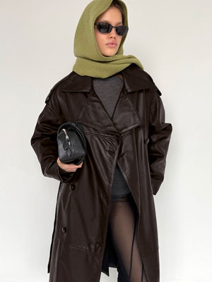 A model wearing a brown leather coat and green scarf, paired with sunglasses and a small black bag, showcasing MEOTINE style.
