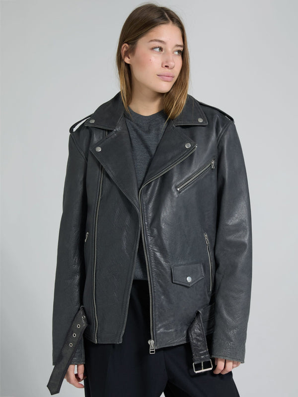 A model wears a stylish black leather biker jacket with silver zippers and a relaxed fit, showcasing MEOTINE's edgy design.