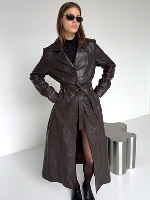 Stylish brown leather trench coat with a belted waist, worn by a model in sunglasses, showcasing MEOTINE's chic design.