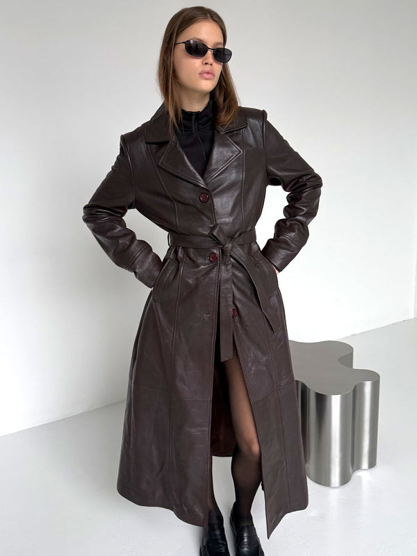 Stylish brown leather trench coat with a belted waist, worn by a model in sunglasses, showcasing MEOTINE's chic design.