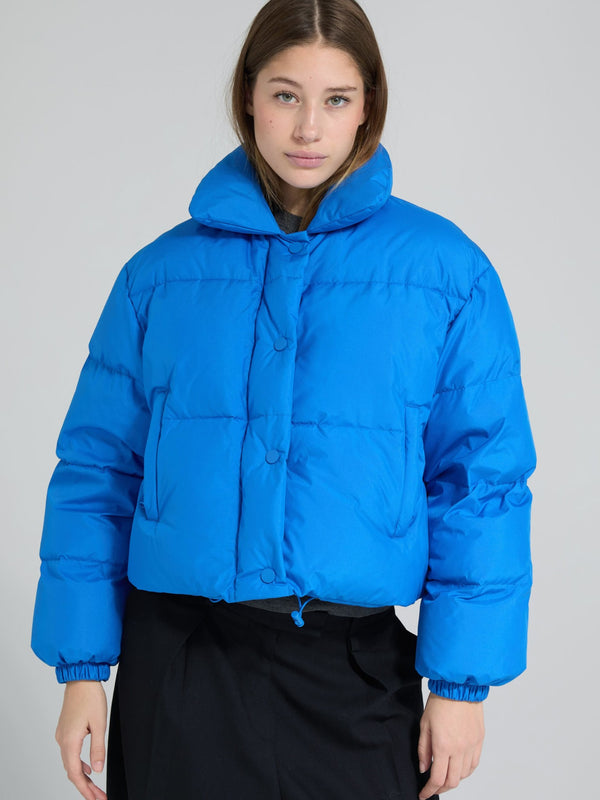 Bright blue cropped puffer jacket with a high collar and button closure, perfect for a stylish winter look by MEOTINE.