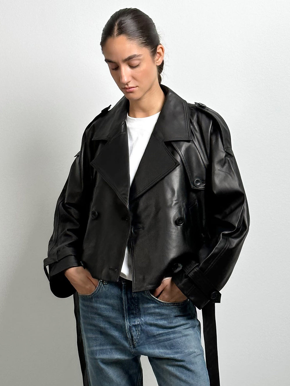 Stylish black cropped leather jacket with double-breasted buttons, perfect for a chic look. From MEOTINE.