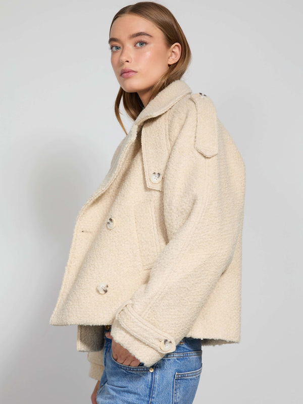 A model showcases a stylish beige MEOTINE jacket with a cozy texture, featuring a double-breasted design and oversized fit.
