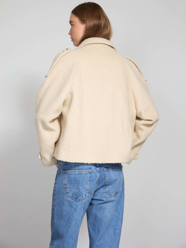 Cozy cream-colored jacket with a textured finish, featuring a relaxed fit and stylish shoulder details, by MEOTINE.