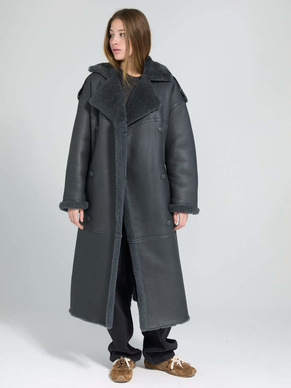 A model showcases a stylish black leather coat with a plush collar and lining, embodying MEOTINE's chic aesthetic.