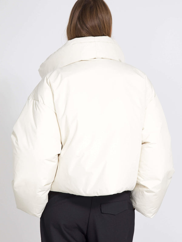 Cozy white puffer jacket with a high collar, perfect for winter layering. Designed by MEOTINE for warmth and style.