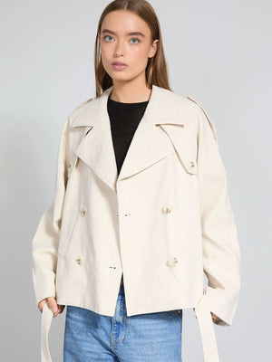 A model wears a stylish cream-colored double-breasted jacket with a relaxed fit, showcasing MEOTINE's contemporary design.