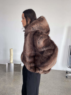 Luxurious brown faux fur coat with a hood, featuring a stylish silhouette, perfect for a chic winter look by MEOTINE.