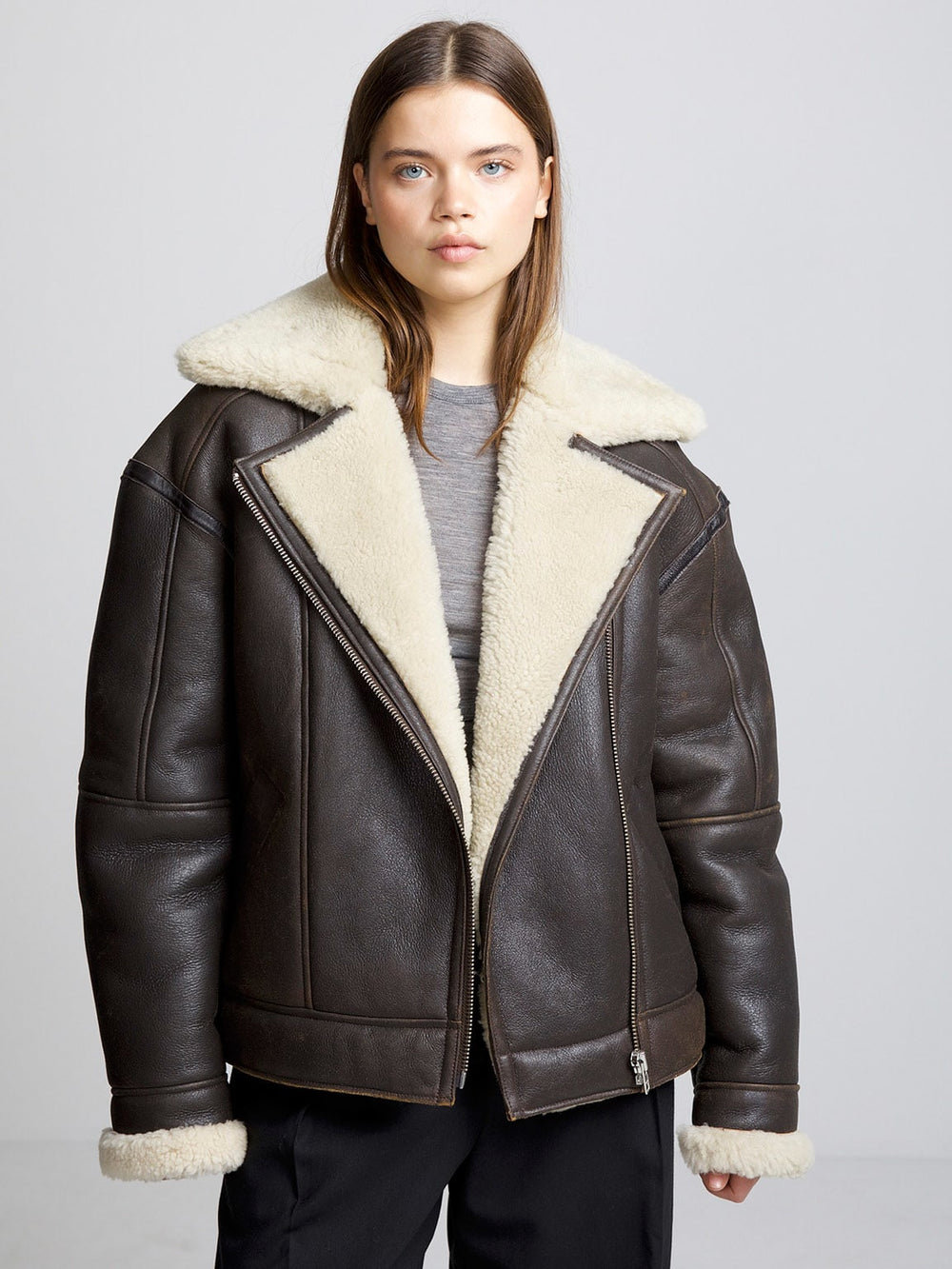 A model wears a stylish brown shearling jacket with a cozy cream collar, showcasing MEOTINE's chic winter fashion.