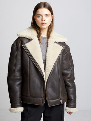 A model wears a stylish brown shearling jacket with a cozy cream collar, showcasing MEOTINE's chic winter fashion.