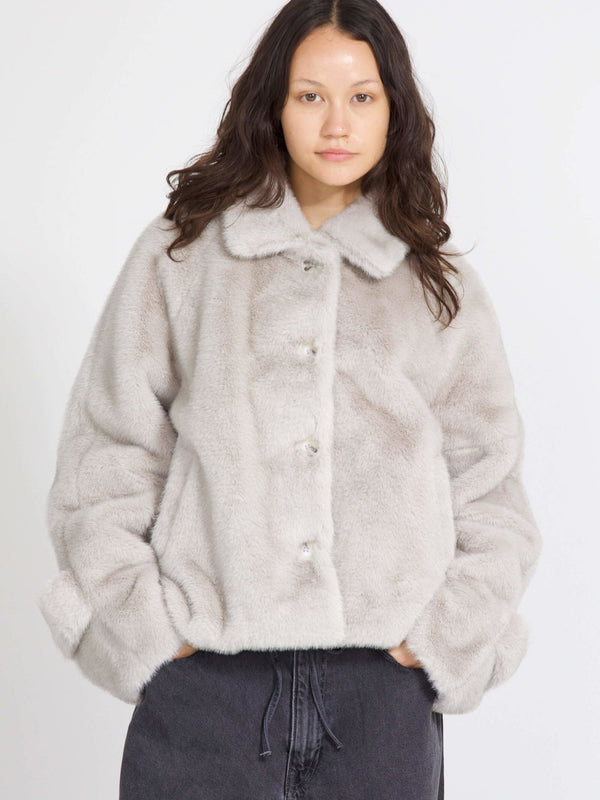 Cozy gray faux fur jacket with a button-up front and relaxed fit, perfect for stylish warmth this season by MEOTINE.