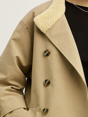 A close-up of a beige coat with a fluffy collar, featuring large buttons, showcasing MEOTINE's stylish design.