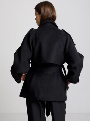 Stylish black coat with a belted waist and oversized sleeves, perfect for a chic look. Designed by MEOTINE.