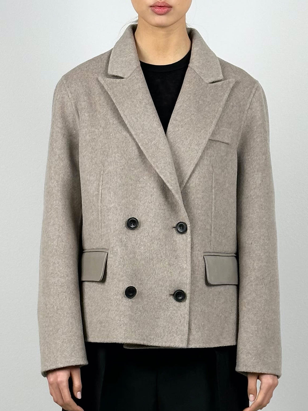 Stylish beige double-breasted coat with black buttons and sleek pockets, perfect for a chic look by MEOTINE.