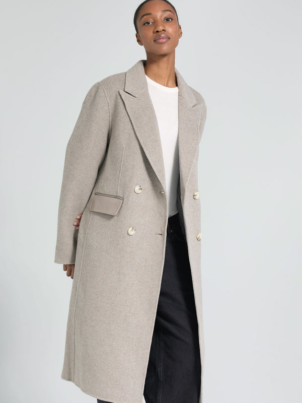 A model showcases a stylish beige double-breasted coat with a pocket, embodying modern elegance by MEOTINE.