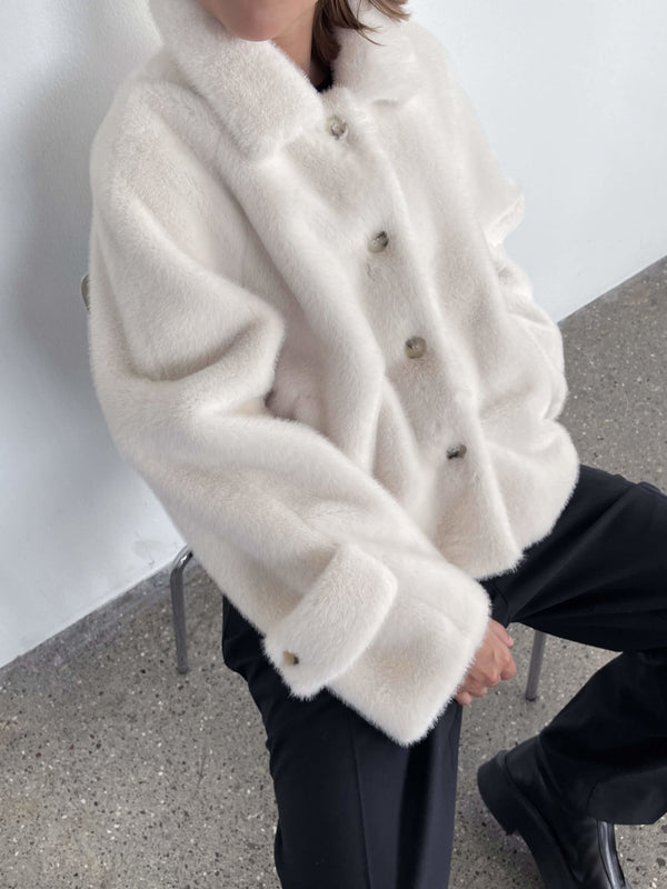 Cozy cream-colored faux fur jacket with a button-up front, perfect for a stylish winter look by MEOTINE.