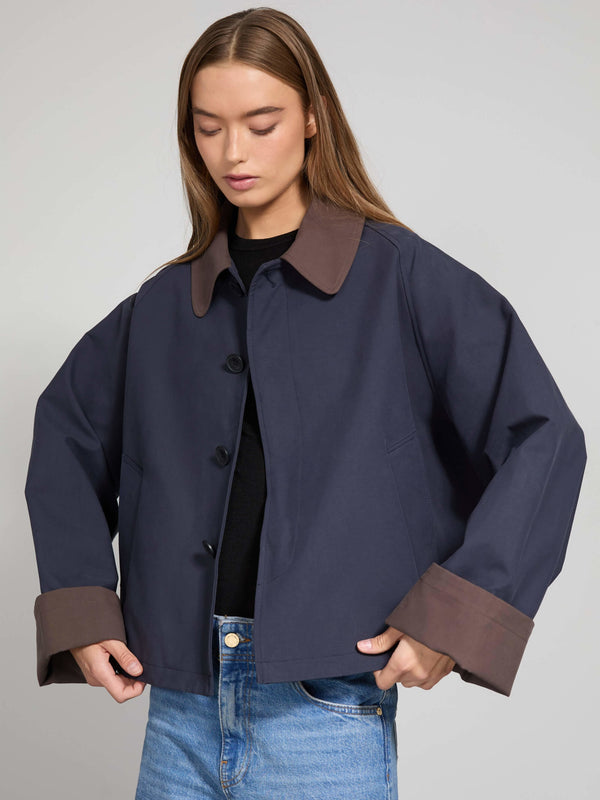 Stylish navy jacket with brown cuffs and collar, perfect for a modern look. Designed by MEOTINE for a chic, casual outfit.