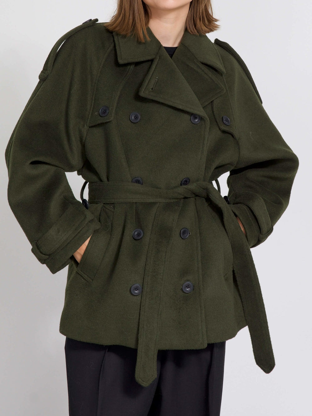A model wears a stylish oversized green coat with a double-breasted design, showcasing MEOTINE's unique fashion aesthetic.