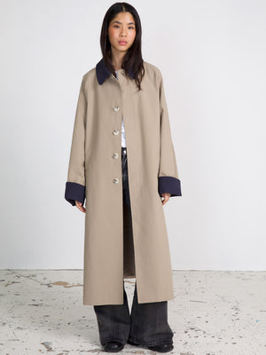 A stylish beige long coat with a navy collar and cuffs, perfect for a chic look. Designed by MEOTINE for modern elegance.