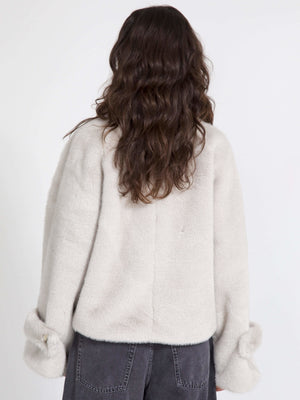 Cozy, oversized cream sweater with soft texture and stylish cuffed sleeves, perfect for a relaxed look by MEOTINE.