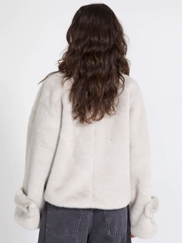 Cozy, oversized cream sweater with soft texture and stylish cuffed sleeves, perfect for a relaxed look by MEOTINE.