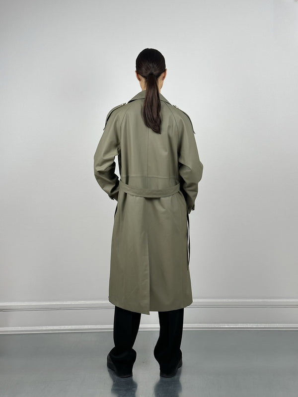 A model wearing a stylish olive green trench coat from MEOTINE, showcasing the back view with a sleek ponytail hairstyle.