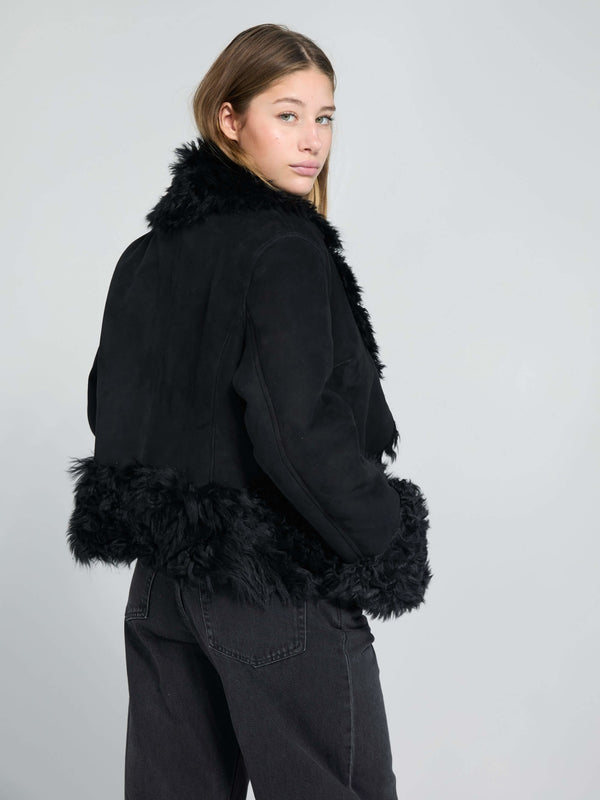 Stylish black faux fur jacket with a cozy collar and hem, perfect for a chic look. Designed by MEOTINE for modern elegance.