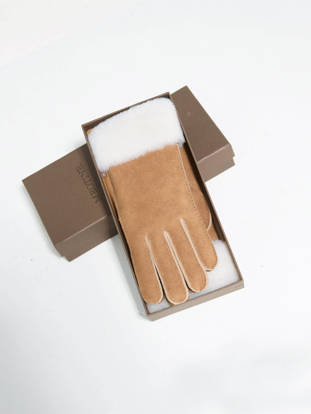 Soft brown gloves with a plush white fur cuff, perfect for winter warmth. Ideal accessory from MEOTINE for chilly days.
