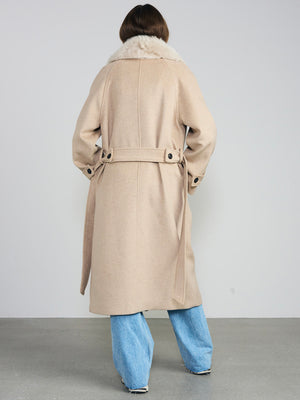 A model wearing a beige coat with a fur collar and a belt, paired with light blue wide-leg jeans, showcasing MEOTINE's elegant style.