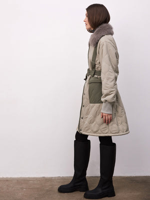 Stylish MEOTINE quilted coat with a fur collar, featuring a belted waist and contrasting green patches, perfect for winter fashion.