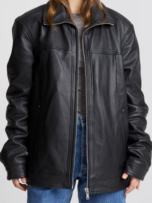 Stylish black leather jacket with a relaxed fit, featuring a zip closure and side pockets, perfect for a trendy look by MEOTINE.