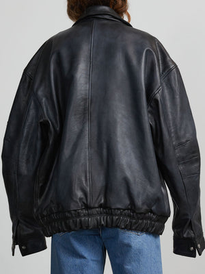 Oversized black leather jacket with a cinched waist, showcasing a relaxed fit and stylish design by MEOTINE.