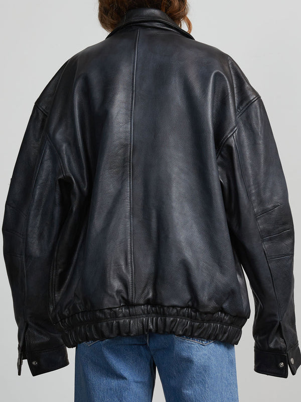 Oversized black leather jacket with a cinched waist, showcasing a relaxed fit and stylish design by MEOTINE.