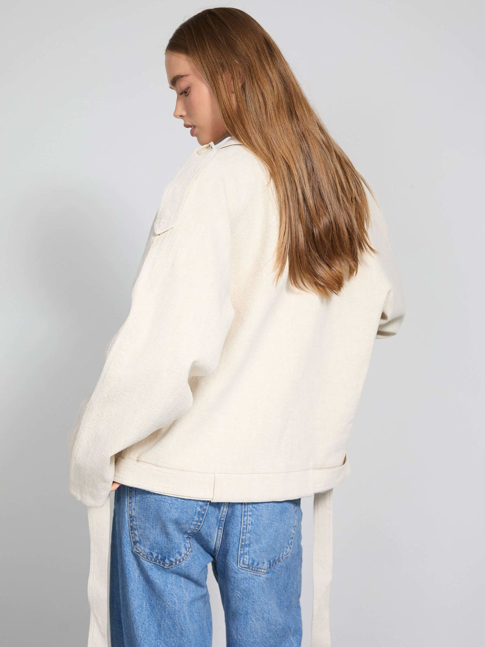 A model wears a stylish cream-colored double-breasted jacket with a relaxed fit, showcasing MEOTINE's contemporary design.