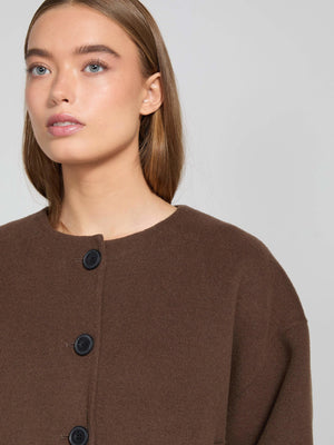 A model showcases a brown wool blend coat with a round neckline and black buttons, representing the MEOTINE brand's elegant style.