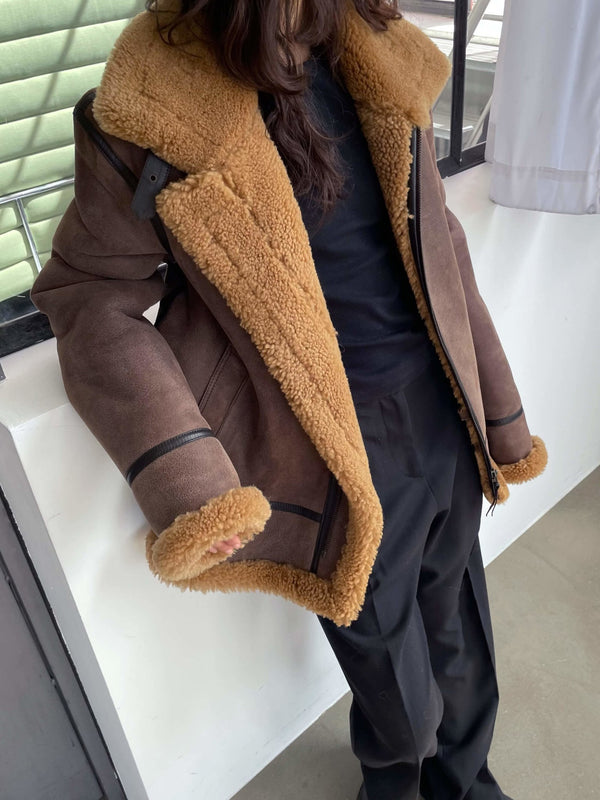 Cozy brown shearling jacket with a plush tan collar, styled with black pants, perfect for a warm, fashionable look by MEOTINE.