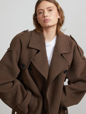 A model wearing a stylish oversized brown coat with a double-breasted design, showcasing MEOTINE's contemporary fashion.